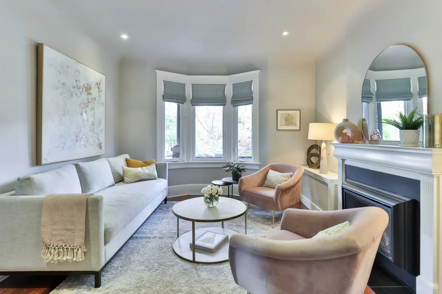 A renovated London living room with a bay window and a period fireplace